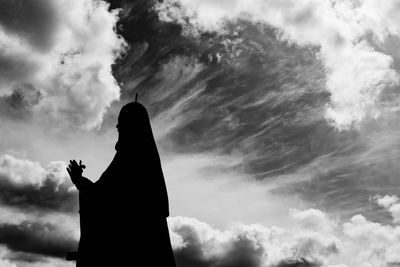 Priest against a cloudy sky