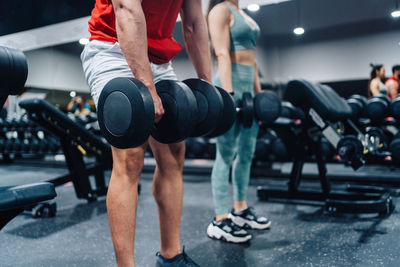 Portrait of couple love in fitness training with dumbbell equipment., young couple are working out