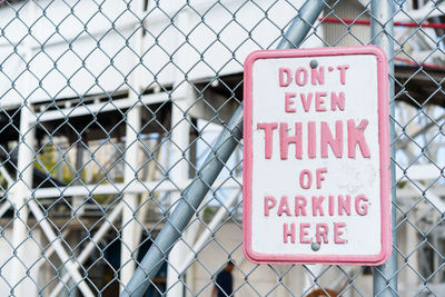 Warning sign on chainlink fence