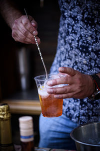 Close-up of hand holding drink glass