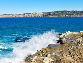 Scenic view of sea against clear blue sky