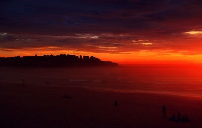 Scenic view of sea against orange sky