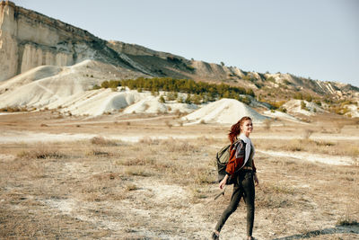 Rear view of woman standing on mountain