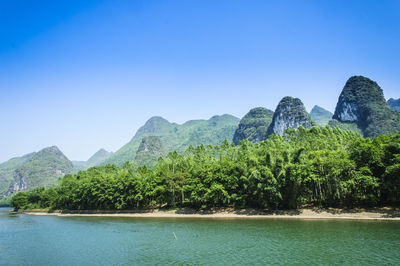 Scenic view of mountains against clear blue sky