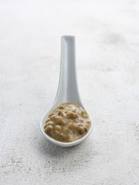 Close-up of bowl on table against white background