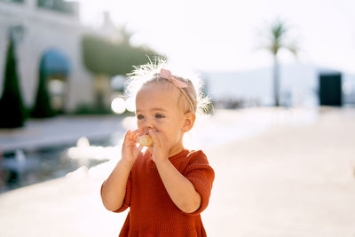 Portrait of cute girl holding camera