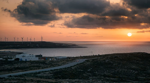 Scenic view of beach against sky during sunset