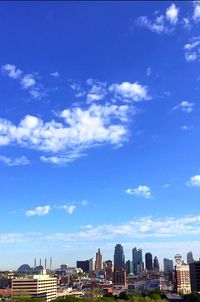 View of cityscape against cloudy sky