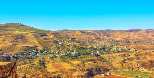 Scenic view of landscape against clear blue sky