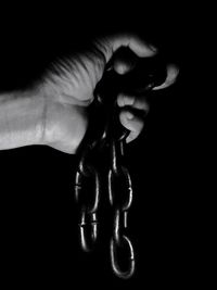 Close-up of woman hand against black background
