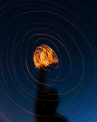 Low angle view of light painting at night