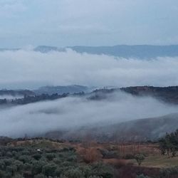 Scenic view of mountains against cloudy sky