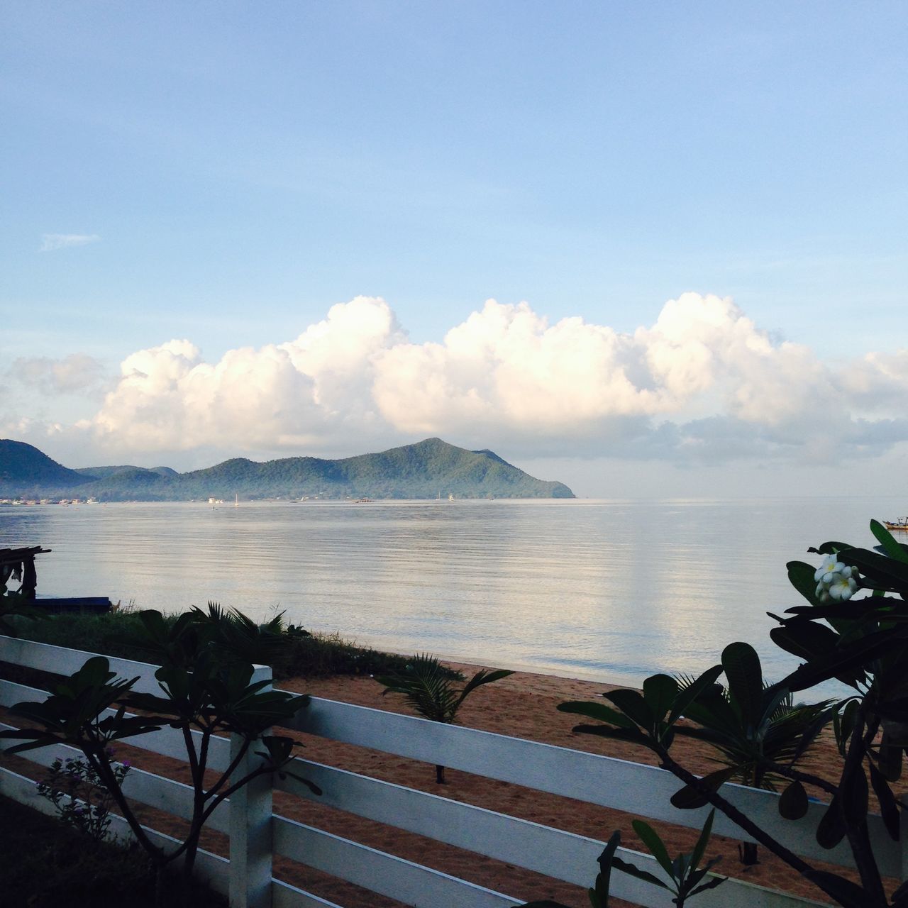 sea, water, sky, tranquility, tranquil scene, scenics, beauty in nature, horizon over water, nature, beach, mountain, idyllic, shore, cloud - sky, railing, cloud, outdoors, day, calm, remote