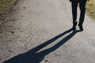 Low section of people standing on road