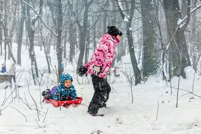 Full length of child on snowy field during winter