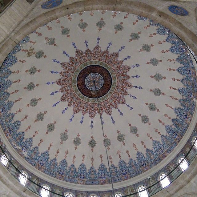 indoors, ceiling, circle, architecture, built structure, low angle view, directly below, geometric shape, pattern, design, skylight, architectural feature, ornate, dome, chandelier, shape, no people, glass - material, famous place, spiral staircase