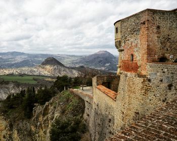 View of fort on mountain against cloudy sky