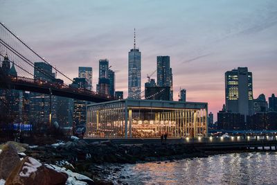 Illuminated buildings in city at dusk