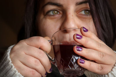 Close-up of woman holding wineglass