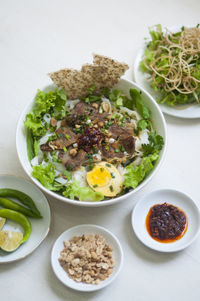 Vietnamese noodle - my quang, vietnamese traditional cuisine, noodles in bowl on the table 