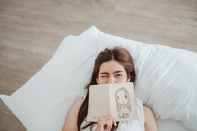 Portrait of woman lying on bed