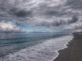 Scenic view of sea against cloudy sky