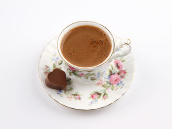 High angle view of coffee on table against white background