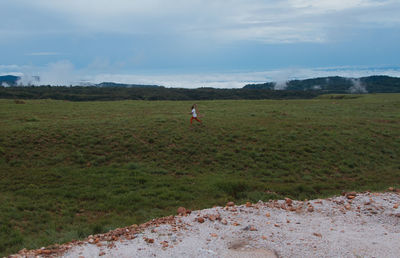 Man on golf course against sky