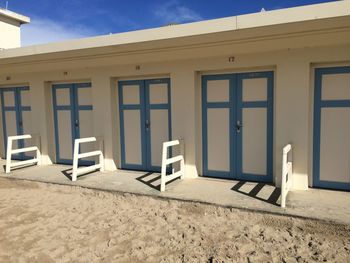 Open sign on beach against buildings in city