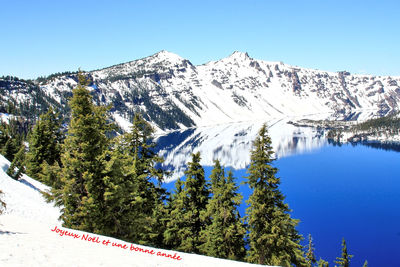 Scenic view of snowcapped mountains against clear blue sky