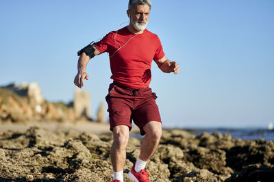 Full length of man running on shore