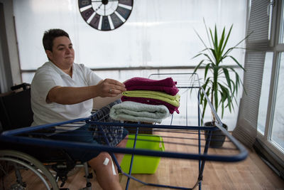Portrait of young man sitting on wheelchair