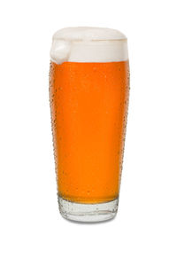 Close-up of beer glass against white background