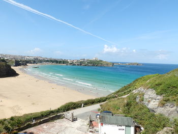 Scenic view of beach against blue sky
