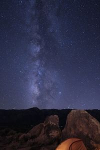 Scenic view of milky-way before mountains against sky at night