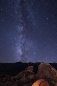 Scenic view of mountains against sky at night