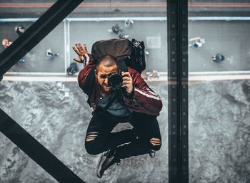 Man photographing through window