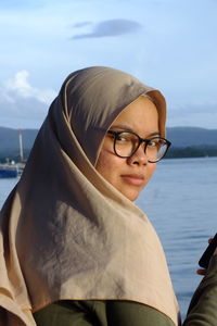 Portrait of woman wearing sunglasses against sky