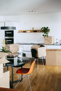 Cardboard boxes and furniture on hardwood floor at new home