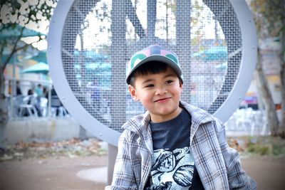 Portrait of young woman standing against sky