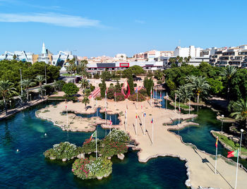 High angle view of swimming pool by buildings against sky