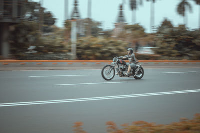 Bicycles riding motorcycle on road,i'm feeling free