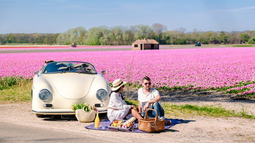 Rear view of man sitting on field