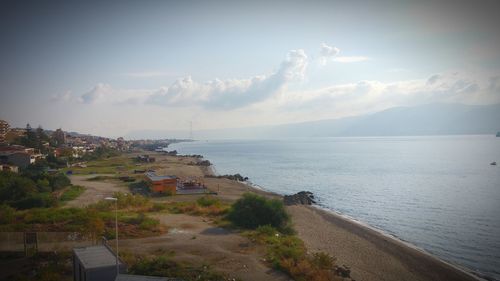 High angle view of sea and buildings against sky