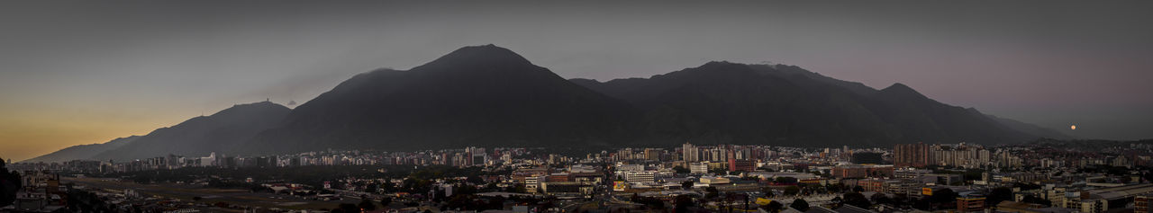 Panoramic view of cityscape against sky at night