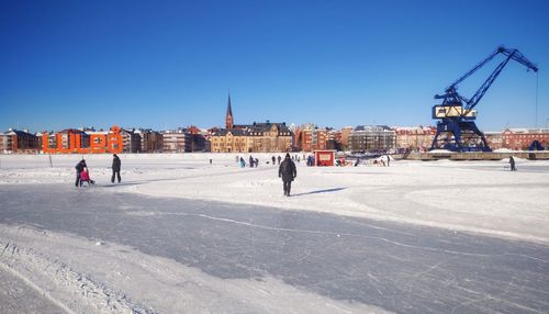 People walking in front of buildings in winter