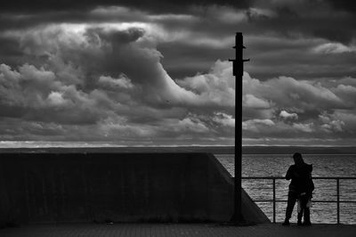 Man photographing sea against sky