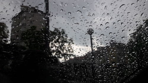 Close-up of wet glass window in rainy season