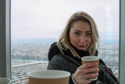 Portrait of woman with coffee cup