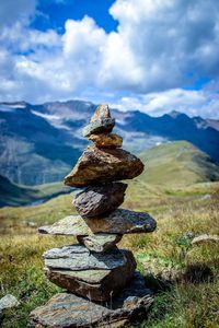 Stack of rocks on mountain against sky